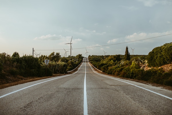 Road with wind turbines in background