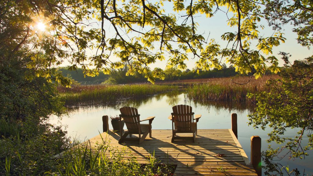 Tranquil Lake Scene with Two Adirondack Chairs