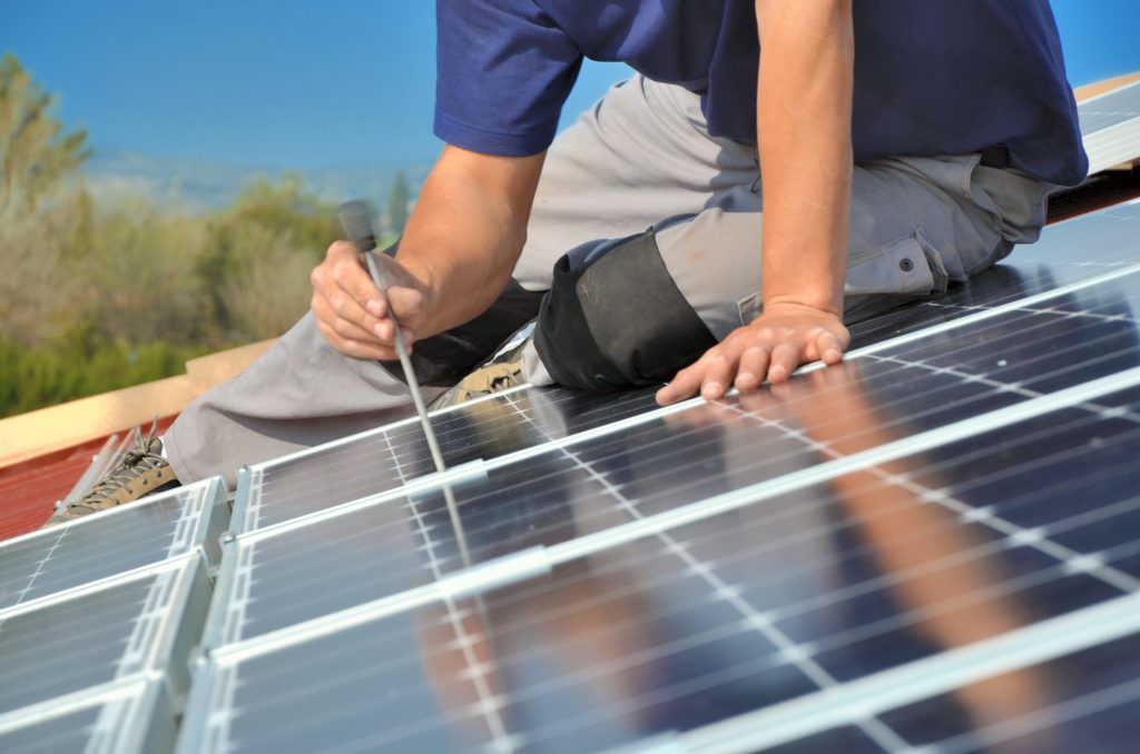 Man installing solar panels