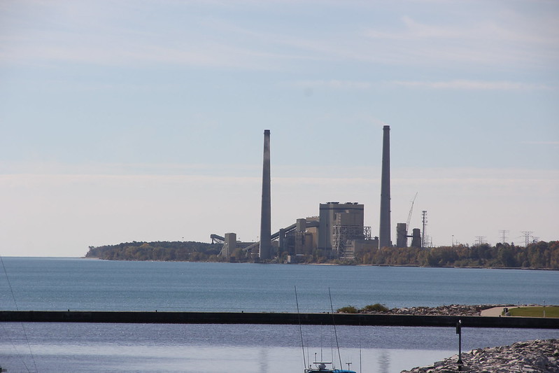 A coal-burning power plant viewed across a body of water