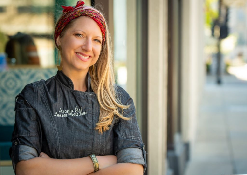 Chef Lauren Montelbano standing on the sidewalk in front of a shop