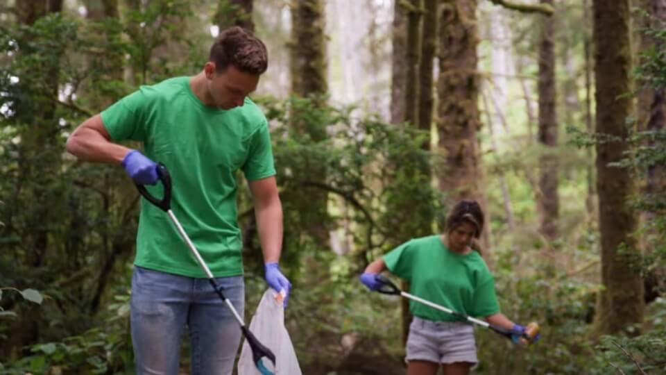 people cleaning up trash in the woods