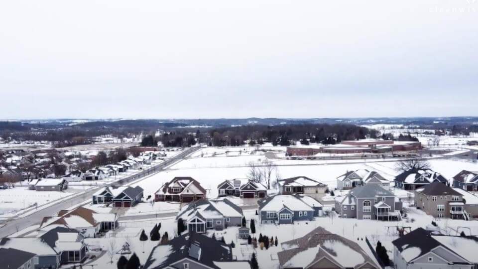 houses in wisconsin covered in snow, aerial view