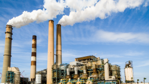 Power plant with smoke billowing from smokestacks