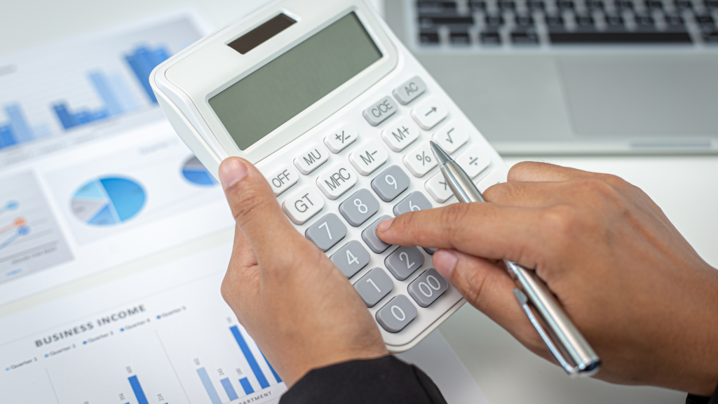 Two hands holding a calculator