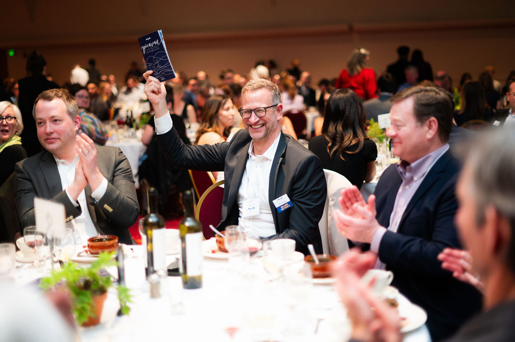 Patrons bid during the Epicurean Evening live auction.