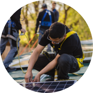 A worker installing solar panels on a roof