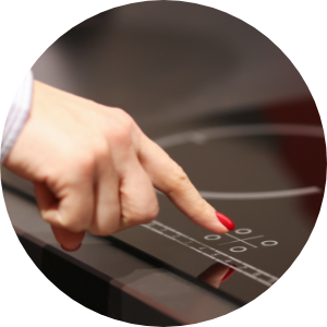A woman activating an electric induction stovetop