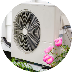 A heat pump with flowers in the foreground