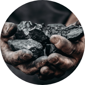 Dirty hands holding lumps of coal