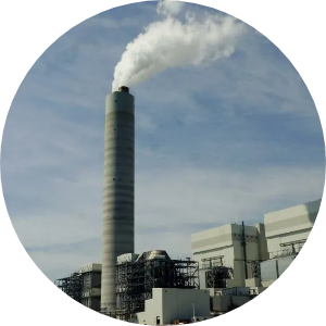 A smokestack of a coal plant spews smoke into the air