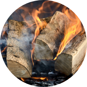 Split logs on fire releasing smoke into the air