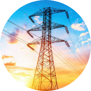 Modern transmission lines against a sunset sky