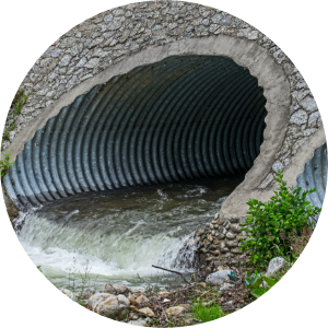 A storm water drain with water running out of it