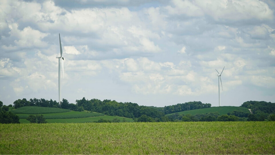 wind turbines in a field on a cloudy day