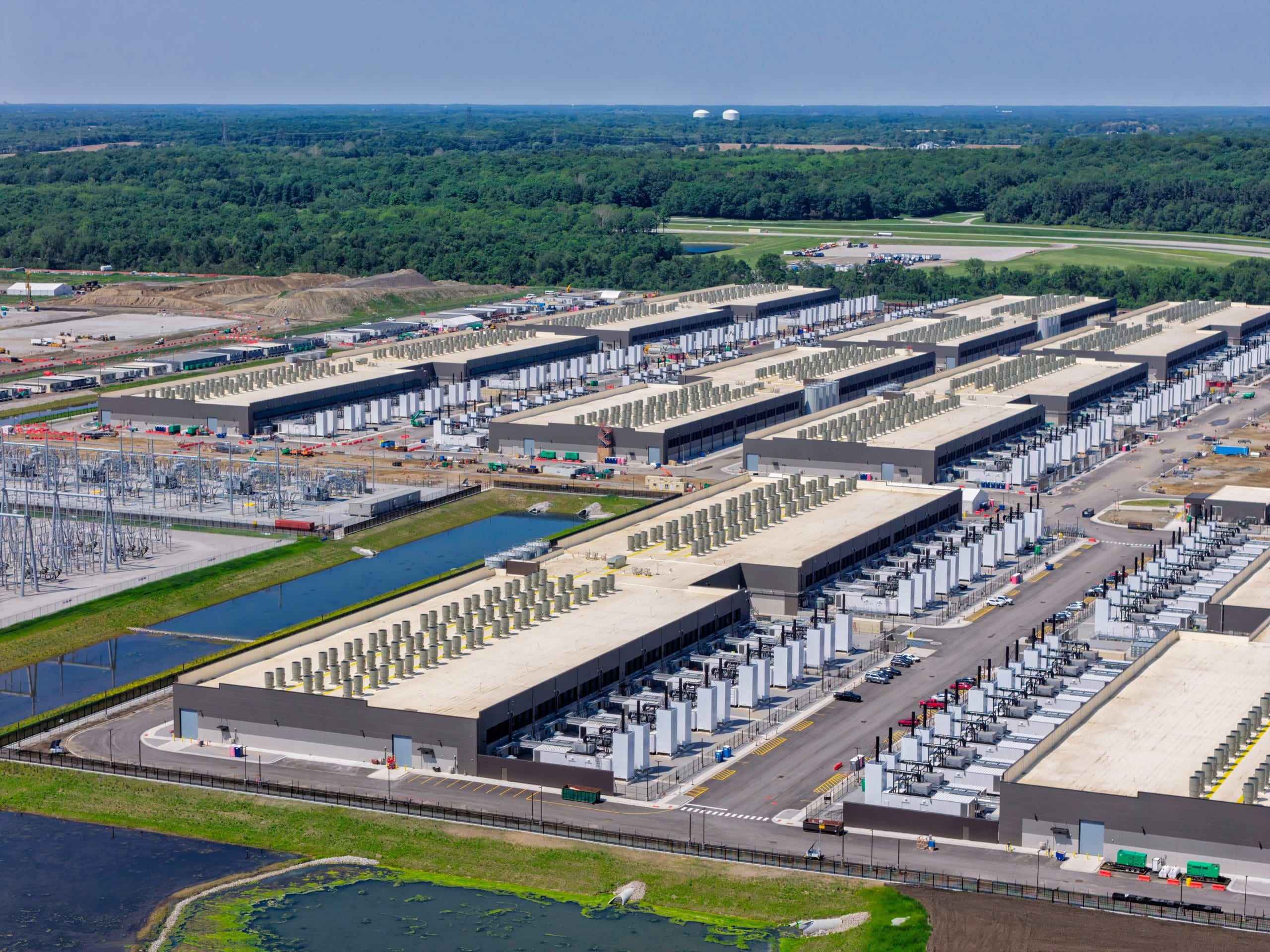 Aerial view of the construction of data center complex, large AI center structure surrounded by cooling and power systems